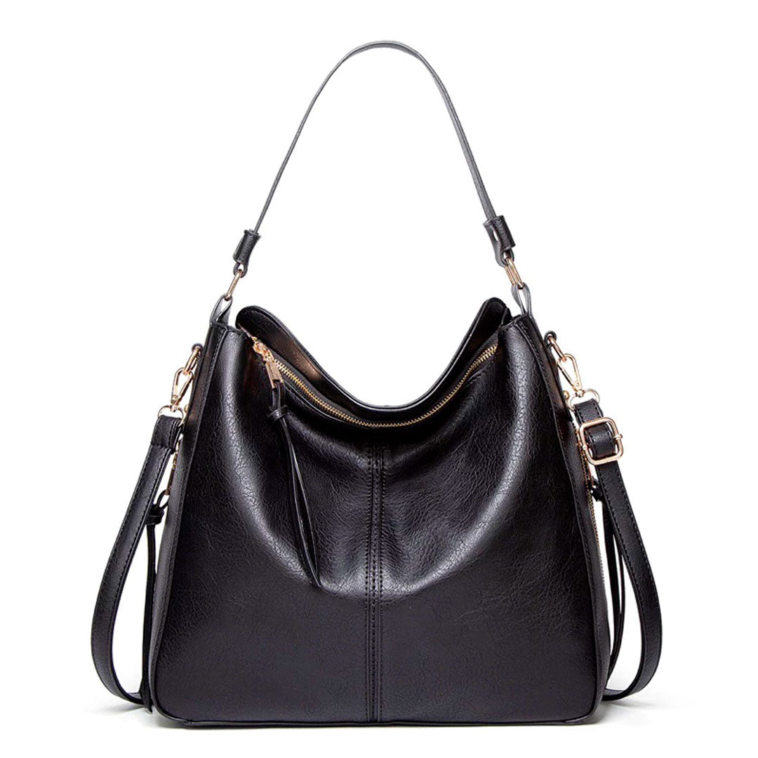 Bolsa de couro feminina com alça dupla, zíper seguro e design elegante. Modelo versátil, disponível em preto e caramelo, ideal para o dia a dia com estilo e sofisticação.