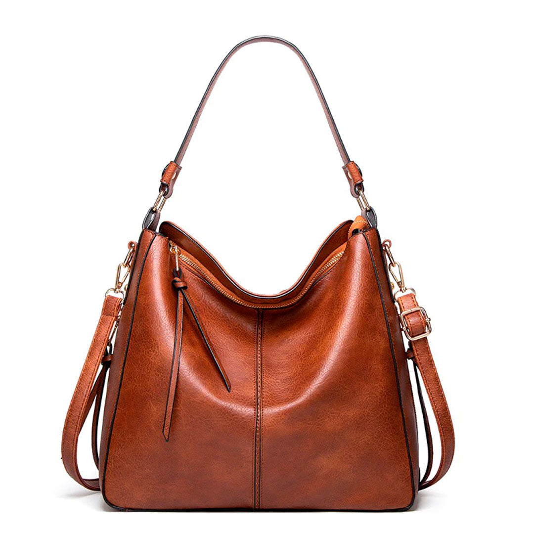 Bolsa de couro feminina com alça dupla, zíper seguro e design elegante. Modelo versátil, disponível em preto e caramelo, ideal para o dia a dia com estilo e sofisticação.
