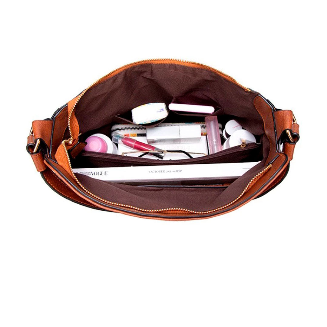 Bolsa de couro feminina com alça dupla, zíper seguro e design elegante. Modelo versátil, disponível em preto e caramelo, ideal para o dia a dia com estilo e sofisticação.