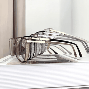 Óculos multifocal feminino com lentes transparentes, armação leve nas cores preta e marrom translúcida. Modelo com proteção contra luz azul e design sofisticado para uso diário.