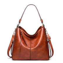 Bolsa de couro feminina com alça dupla, zíper seguro e design elegante. Modelo versátil, disponível em preto e caramelo, ideal para o dia a dia com estilo e sofisticação.
